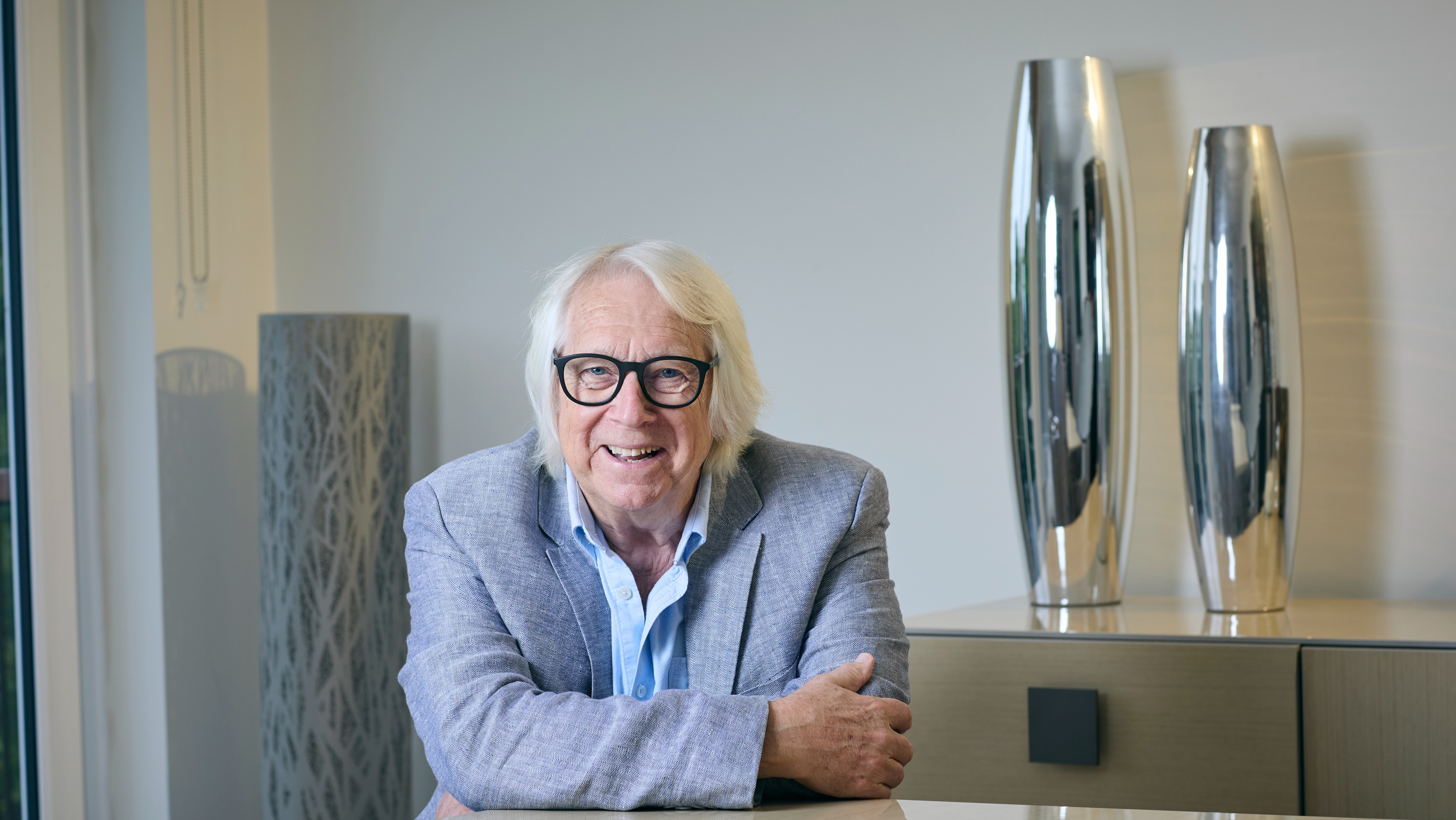 Tony McHale, sitting at a table, smiling
