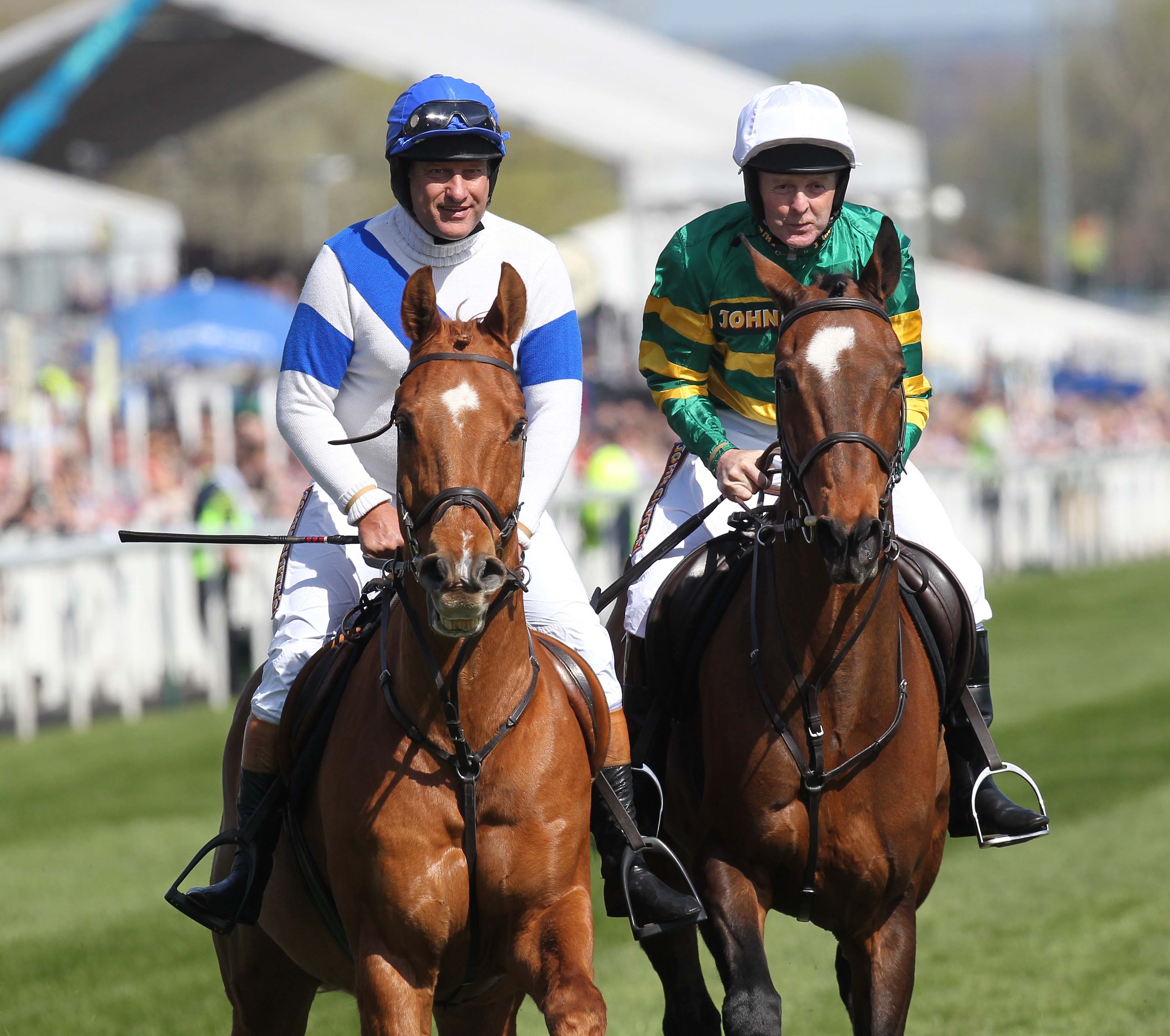 Bob Champion (left) with fellow jockey, JonJo O’Neill (right), both riding horses