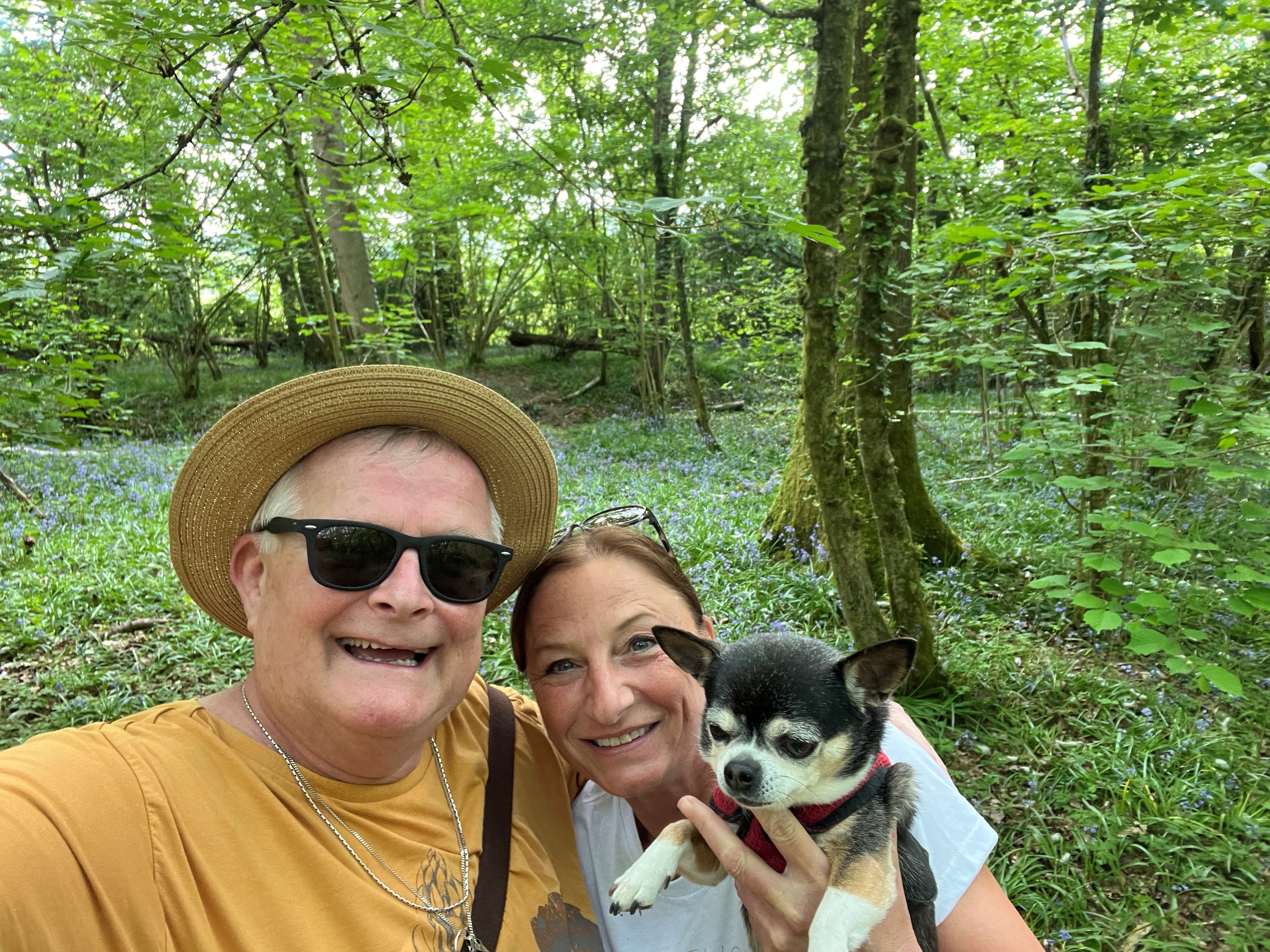 Dave in a bluebell wood with a female friend holding a small dog