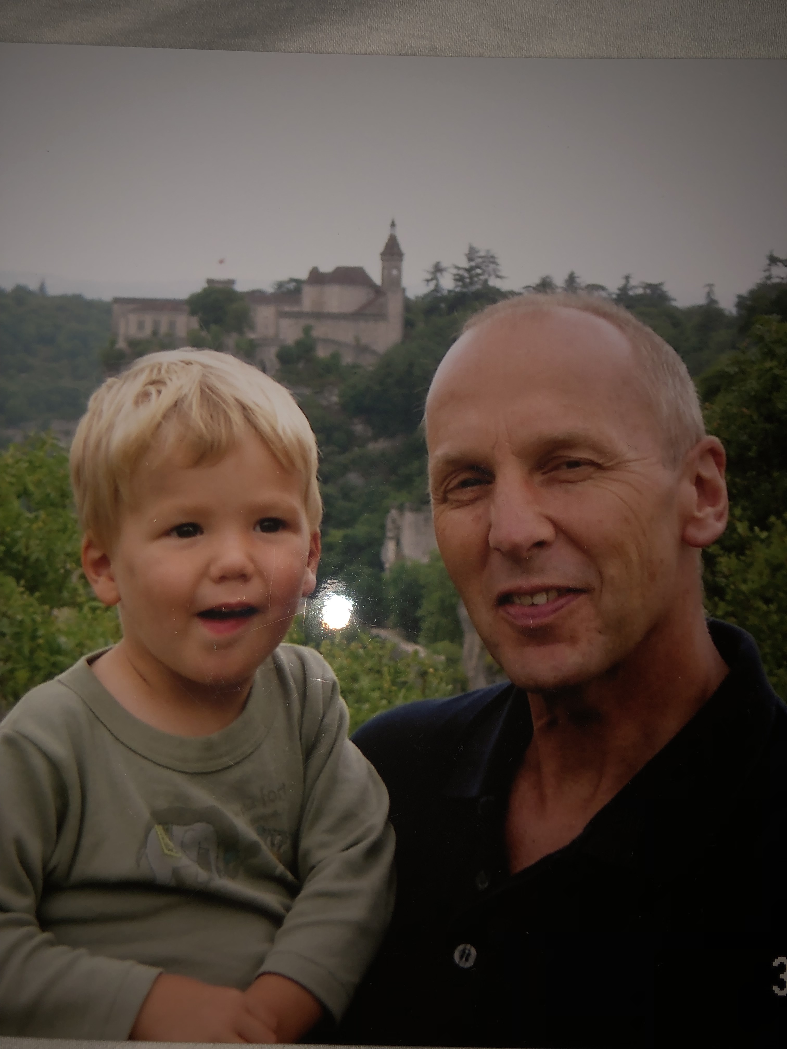 Joe as a young boy is cuddled by his Dad