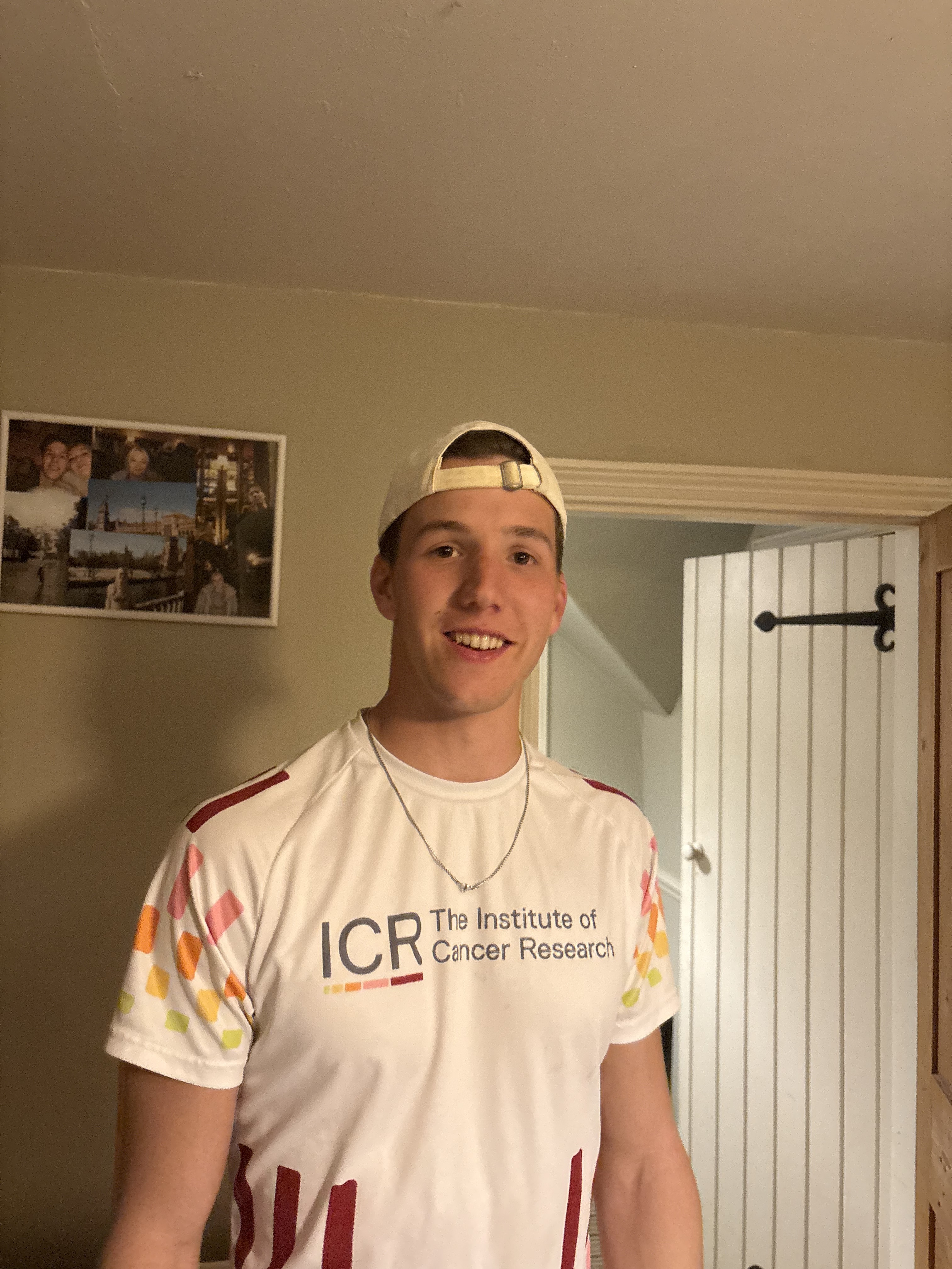 Joe Dale wearing an ICR T-shirt and a baseball cap smiles into the camera