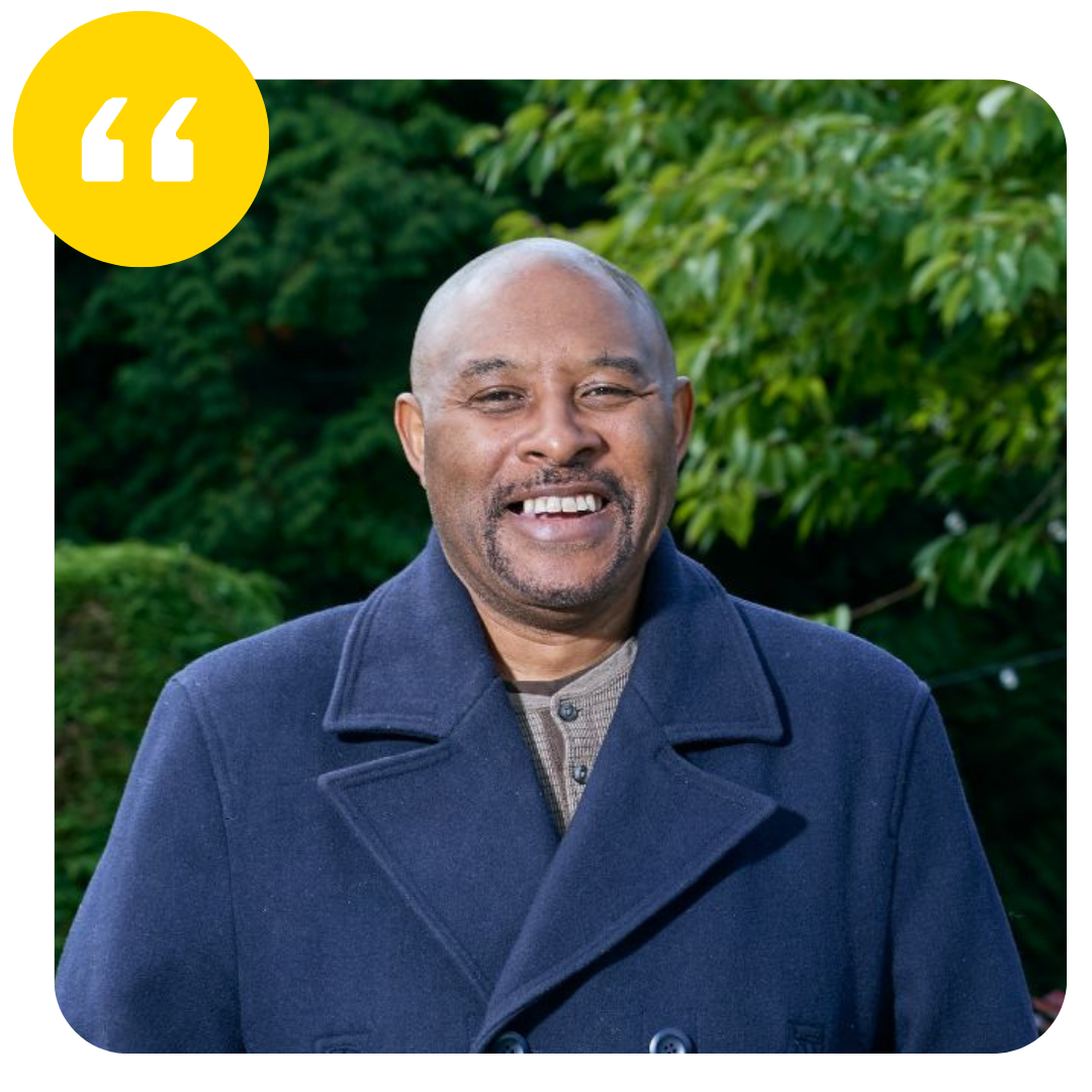 Godfrey smiling with quotation mark