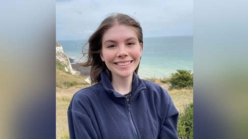 Headshot of Emily Alger by the sea
