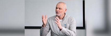 Martin Wells speaking and gesturing with his hands