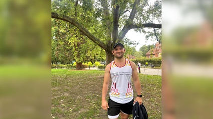 Sam Cooper in a park, wearing an ICR running vest