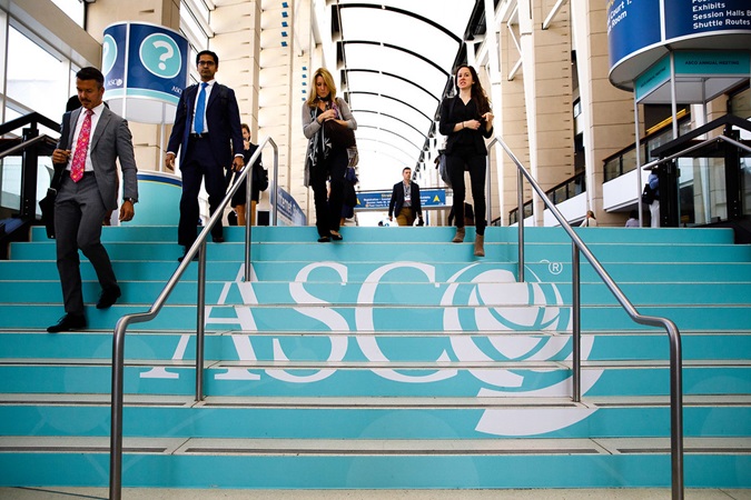 Image of people walking down a set of steps in a conference centre