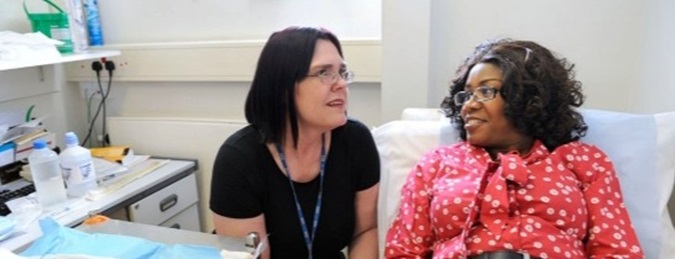 Patient and clinician talking in a hospital room