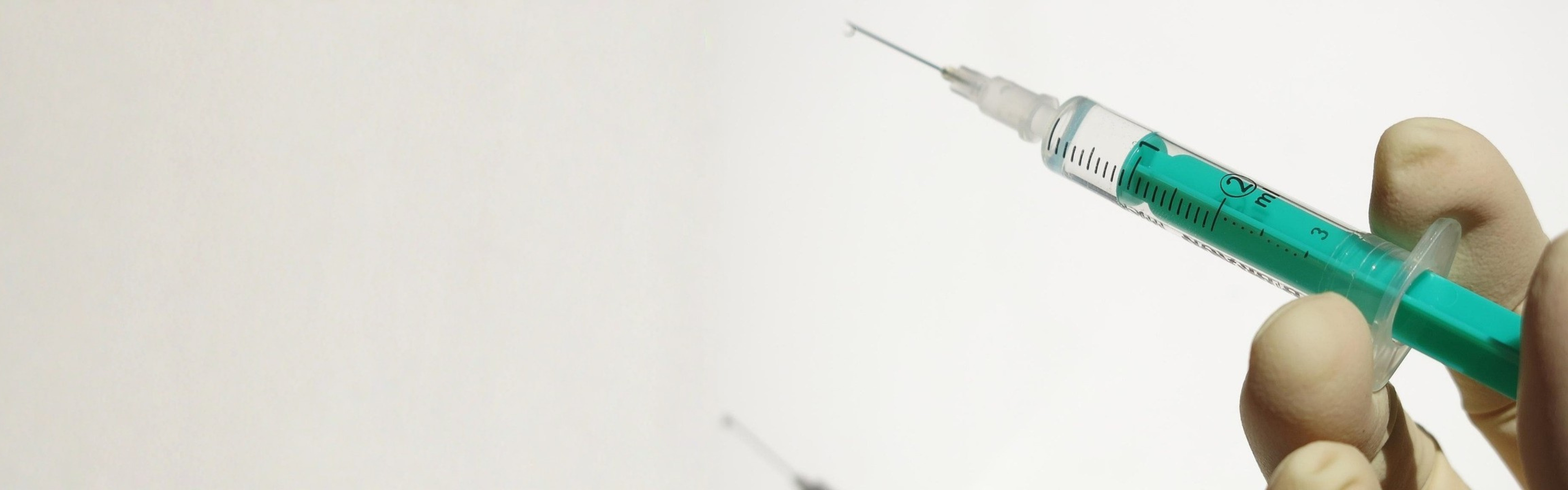 Image of hand holding syringe