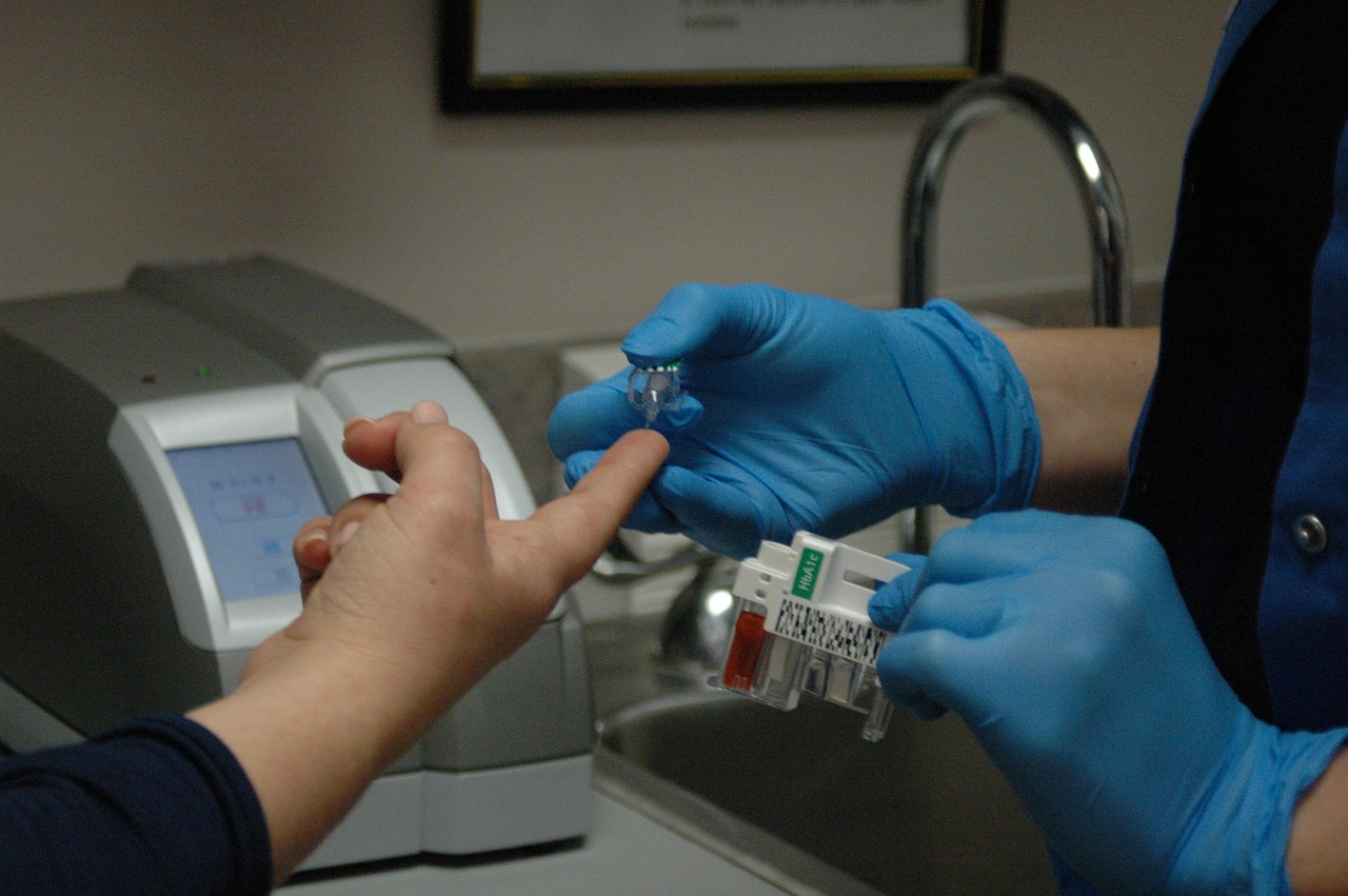 Nurse testing a diabetes patient's blood sugar level