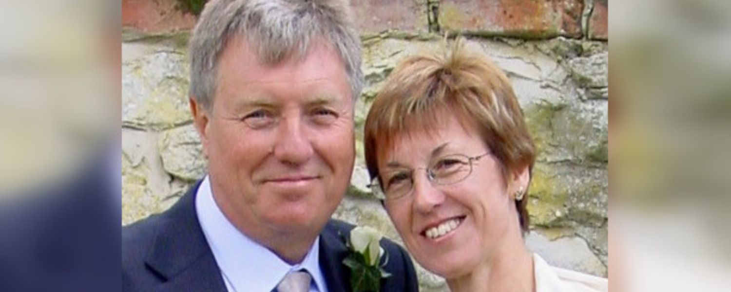 Sue & Philip smiling at their wedding