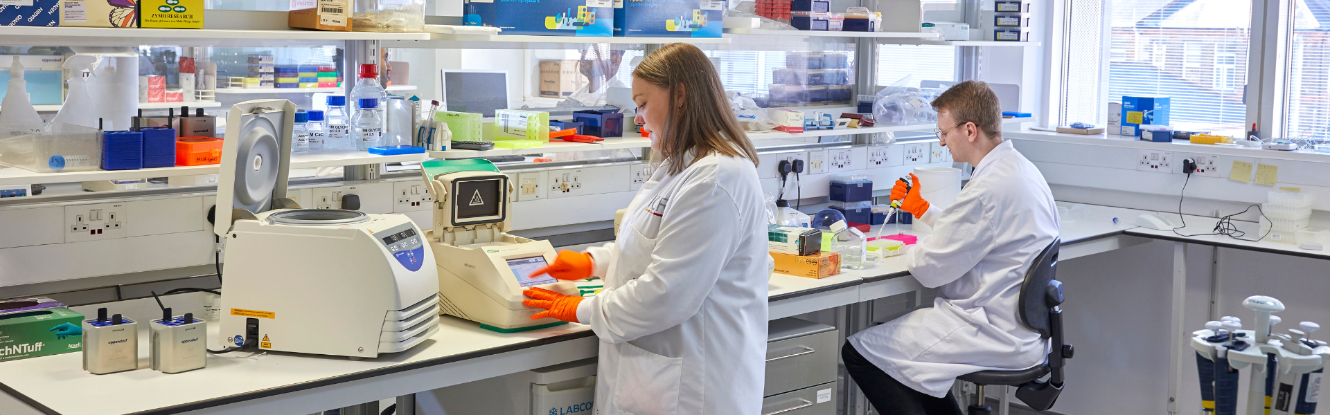 Two ICR scientists, one female, one male, working in the labs