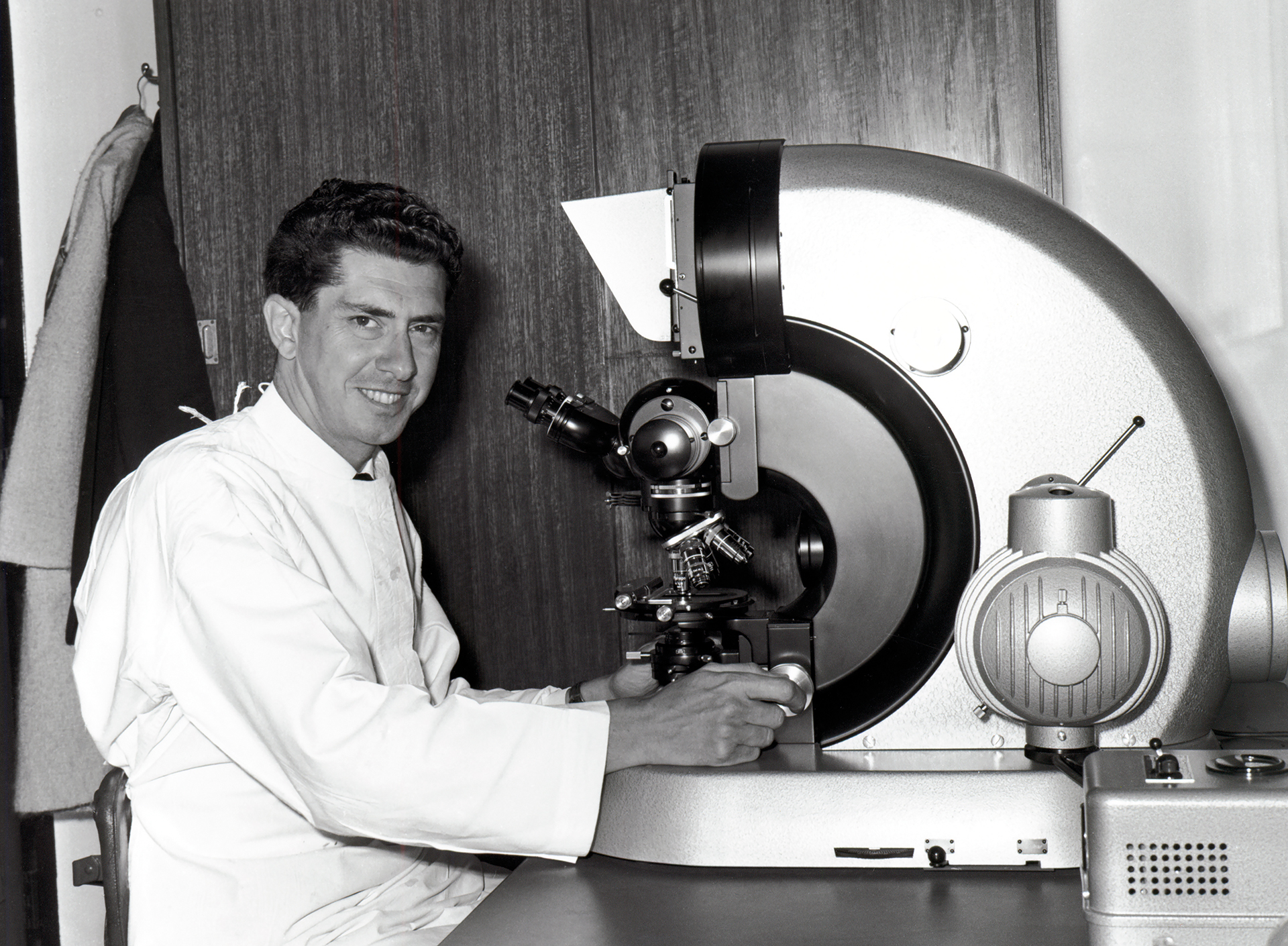 PhD student Jacques Miller sitting at a microscope