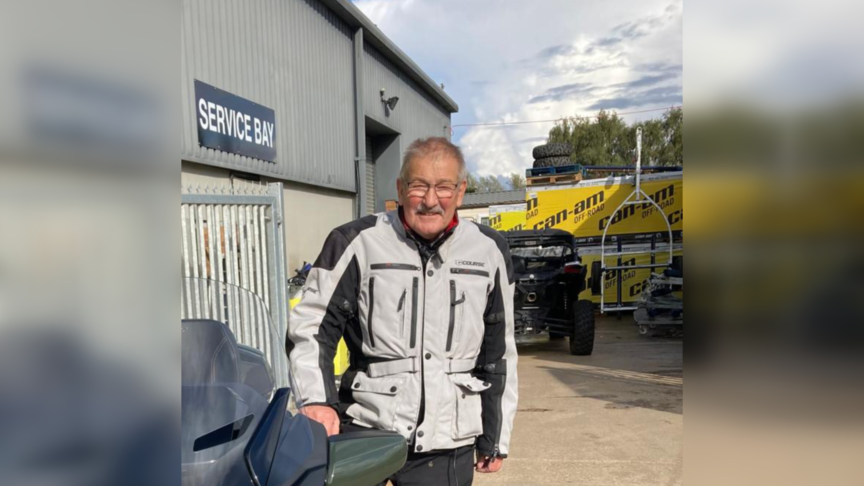 Dorian Burrows in front of a garage