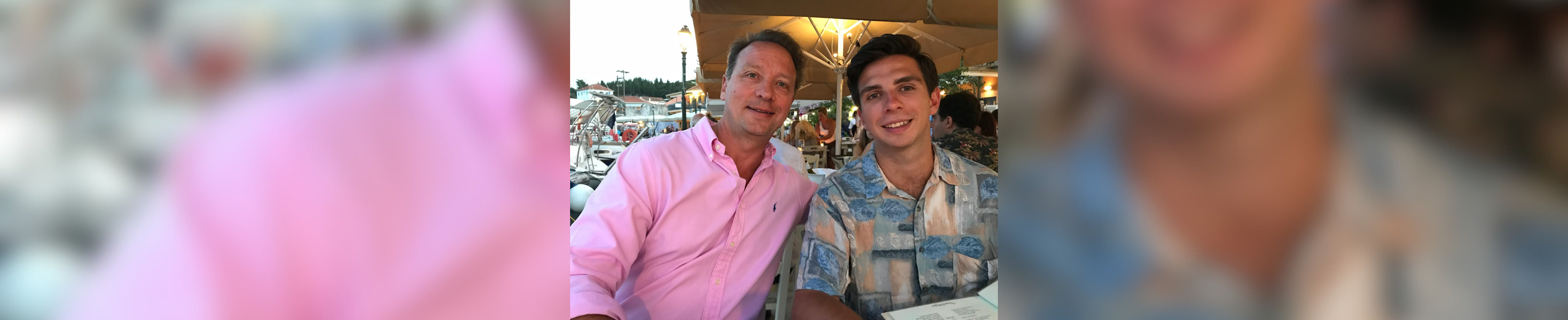 George and Mike smiling together on holiday
