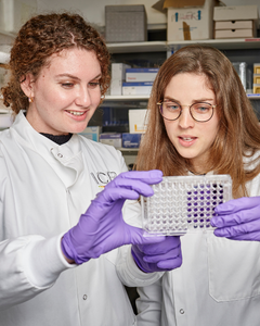 Scientists in lab 240x300px Two women in a lab looking at test results