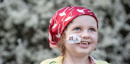 Siobhan of Siobhan's Superstar Legacy Portrait of Siobhan with nasal cannula, wearing a red headscarf